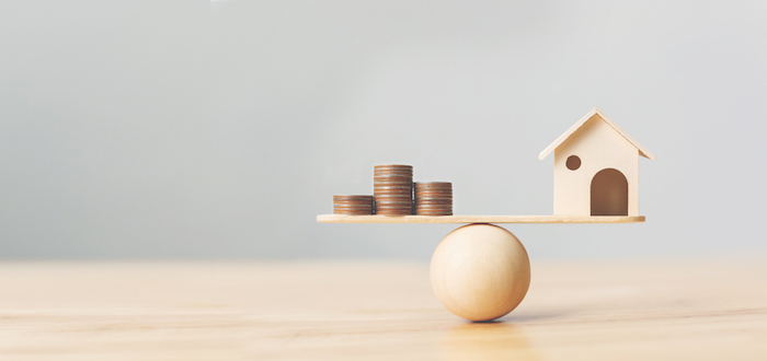 money and house on scale