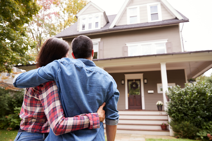 couple admiring home outside