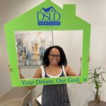 person posing holding dsld sign