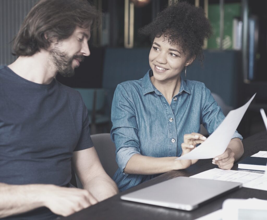 woman and man talking at a desk