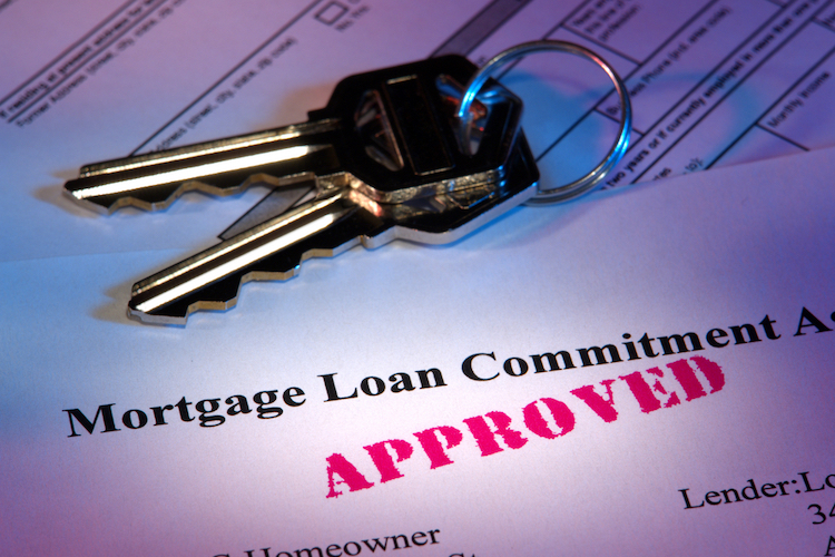 approved mortgage loan commitment document with keys on top 