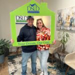 couple posing with sign