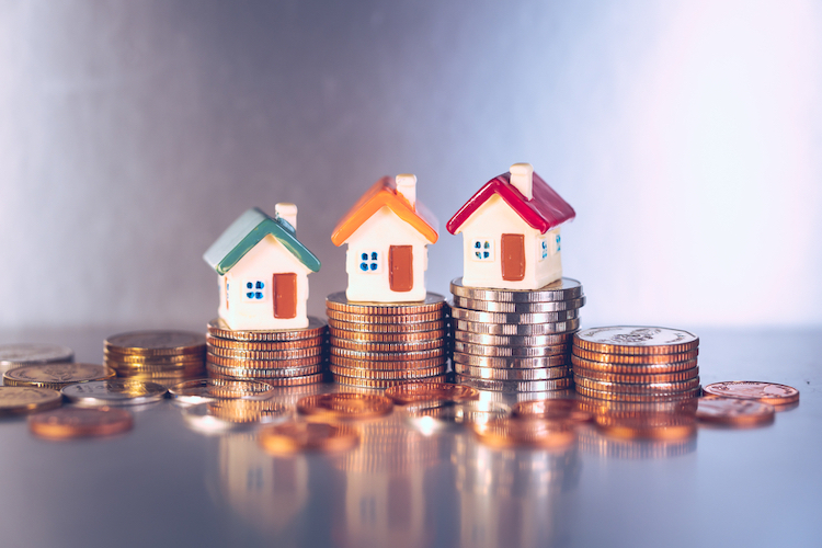 miniature colorful house on stack coins