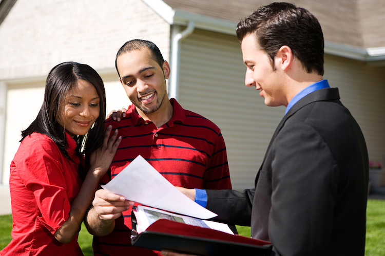 real estate agent sharing information with a couple