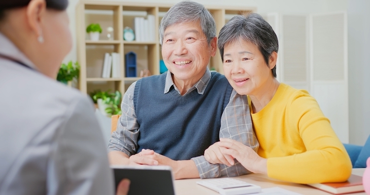 elderly couple in an office buying a house