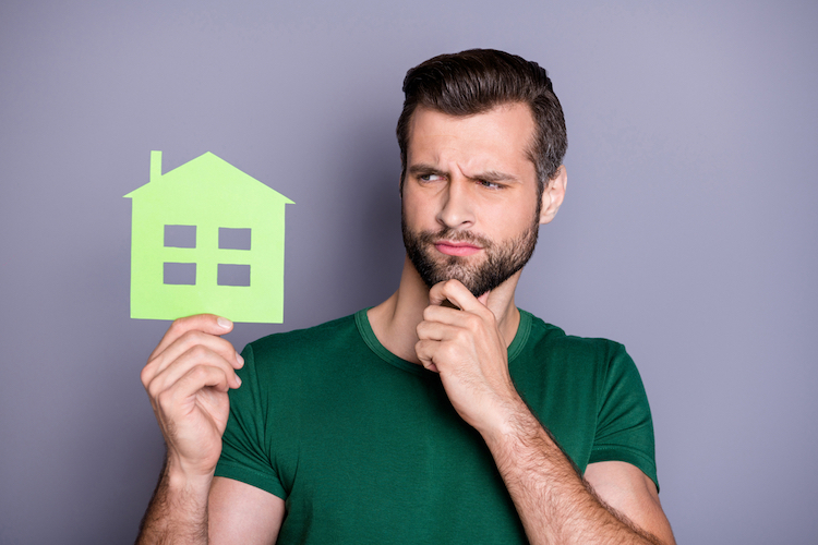 guy hold paper card house cut out