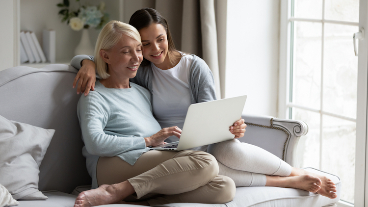 mother daughter resting on sofa