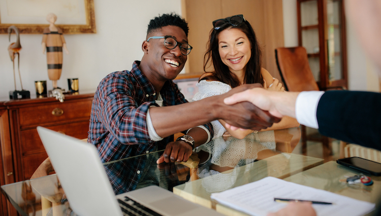 property owners shaking hands with real estate agent