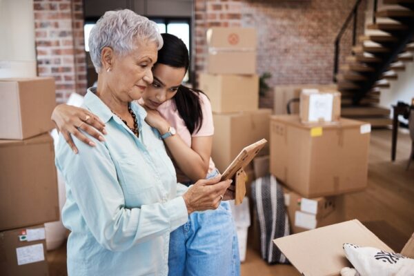 A mother and daughter reading a moving checklist