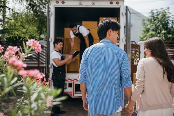 A couple by a moving van