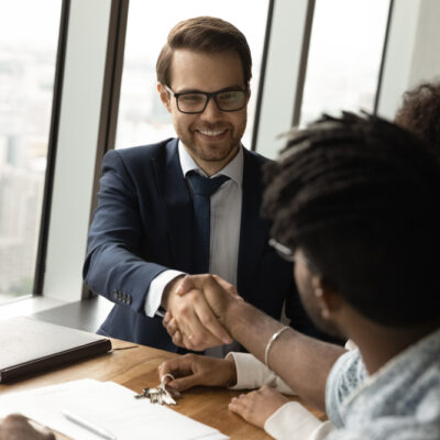 A loan advisor shaking a woman's hand