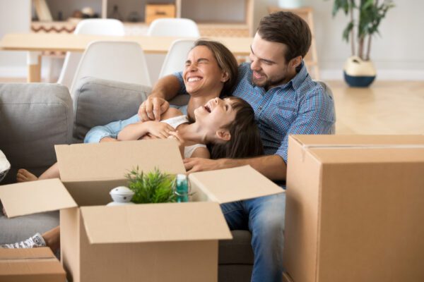 A family surrounded by moving boxes