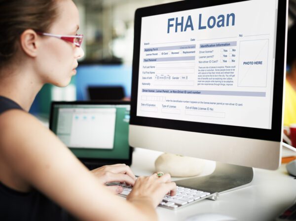 Woman researching FHA Loans on a computer