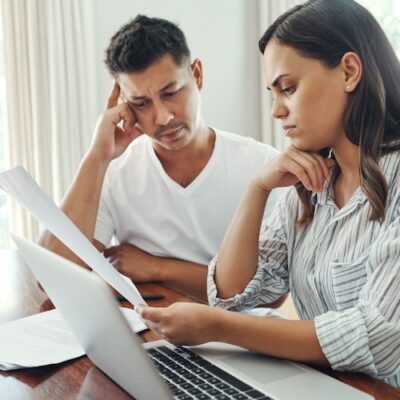 confused couple home budgeting